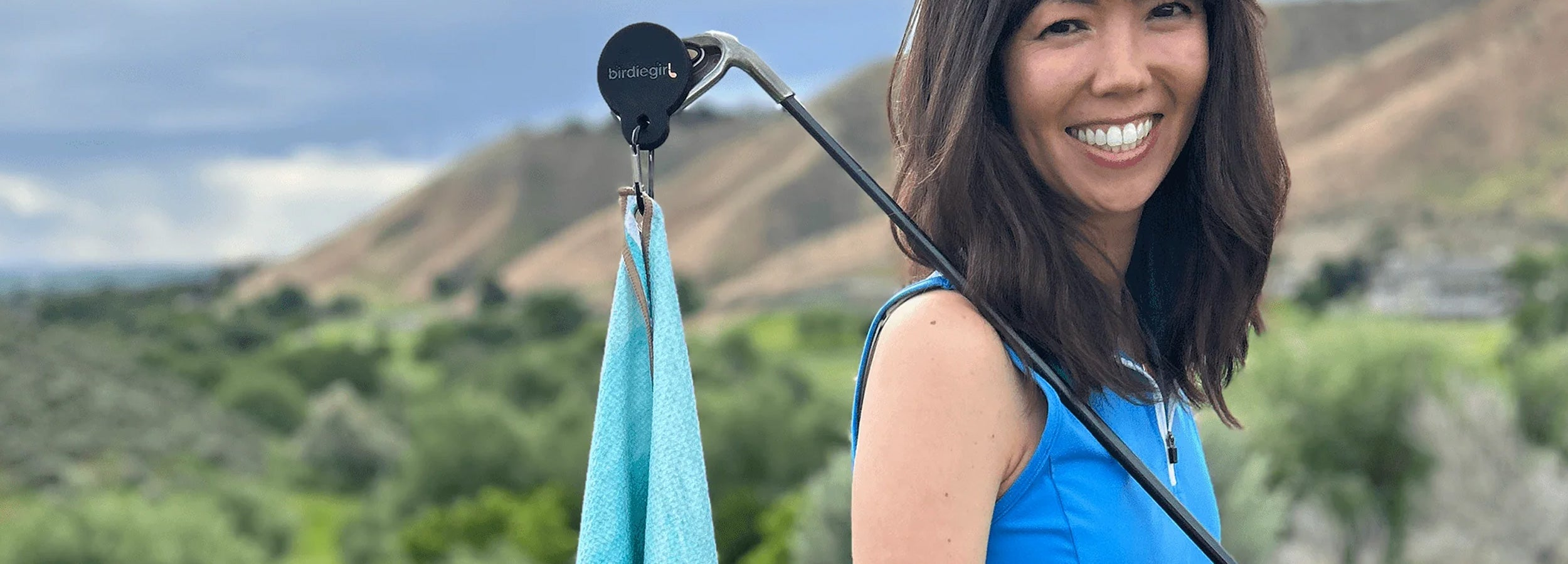 WOman golfer with magnetic birdie girl golf towel